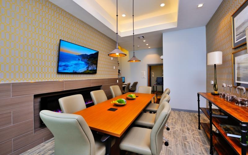 a dining room with a tv and chairs