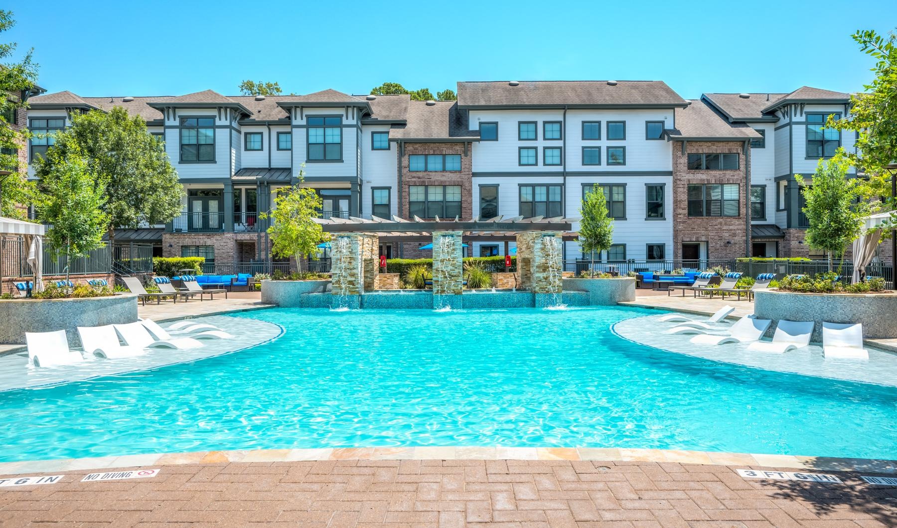 a large building with a pool in front of it