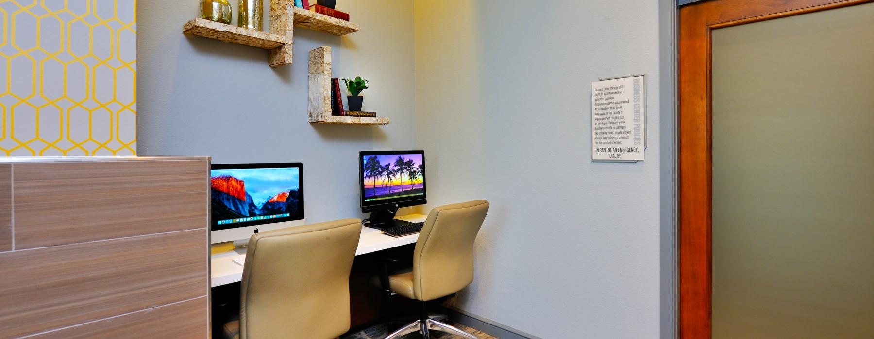 a room with a desk and computer